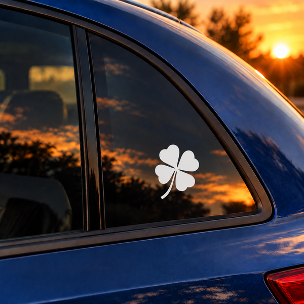 Vinyl clover decal with heart-shaped leaves and curling stem on a car window