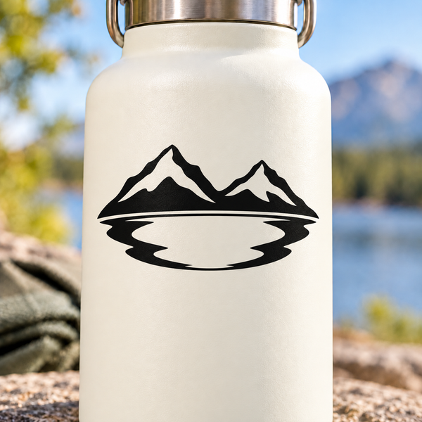 Black vinyl decal with mountain peaks and wavy lake emblem on light bottle
