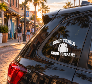 Vinyl decal: “Good Trails Good Company” with black headphones icon on car window