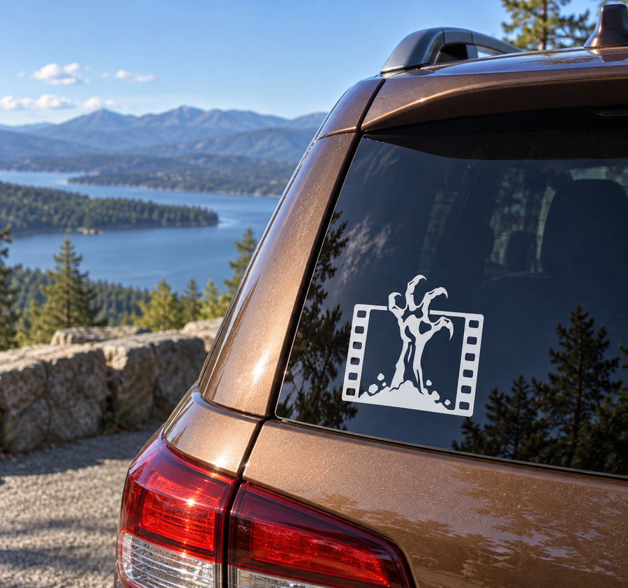 Vinyl decal of a horror creature silhouette in a film-strip frame on a car window