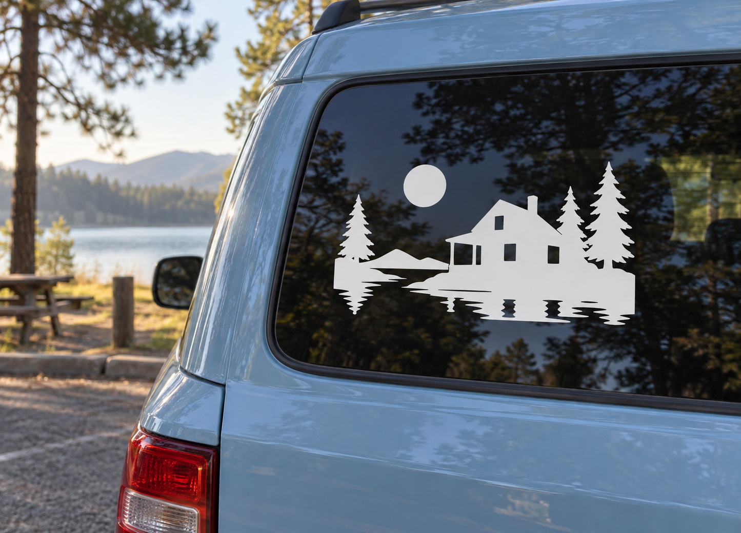 Haunted cabin screen vinyl decal with white house, pine trees, and moon circle