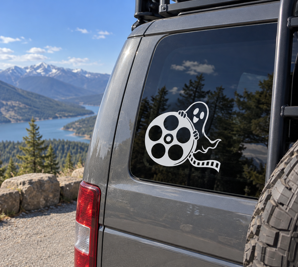 Ghost and film reel vinyl decal on vehicle window, white and black design