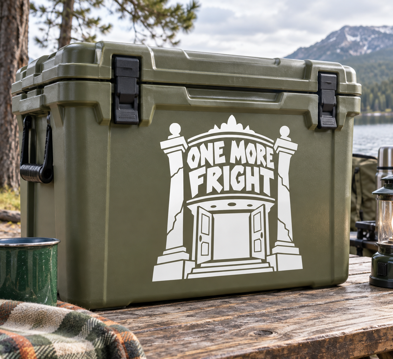 White “One More Fright” vinyl decal on an olive green cooler with haunted doorway graphic