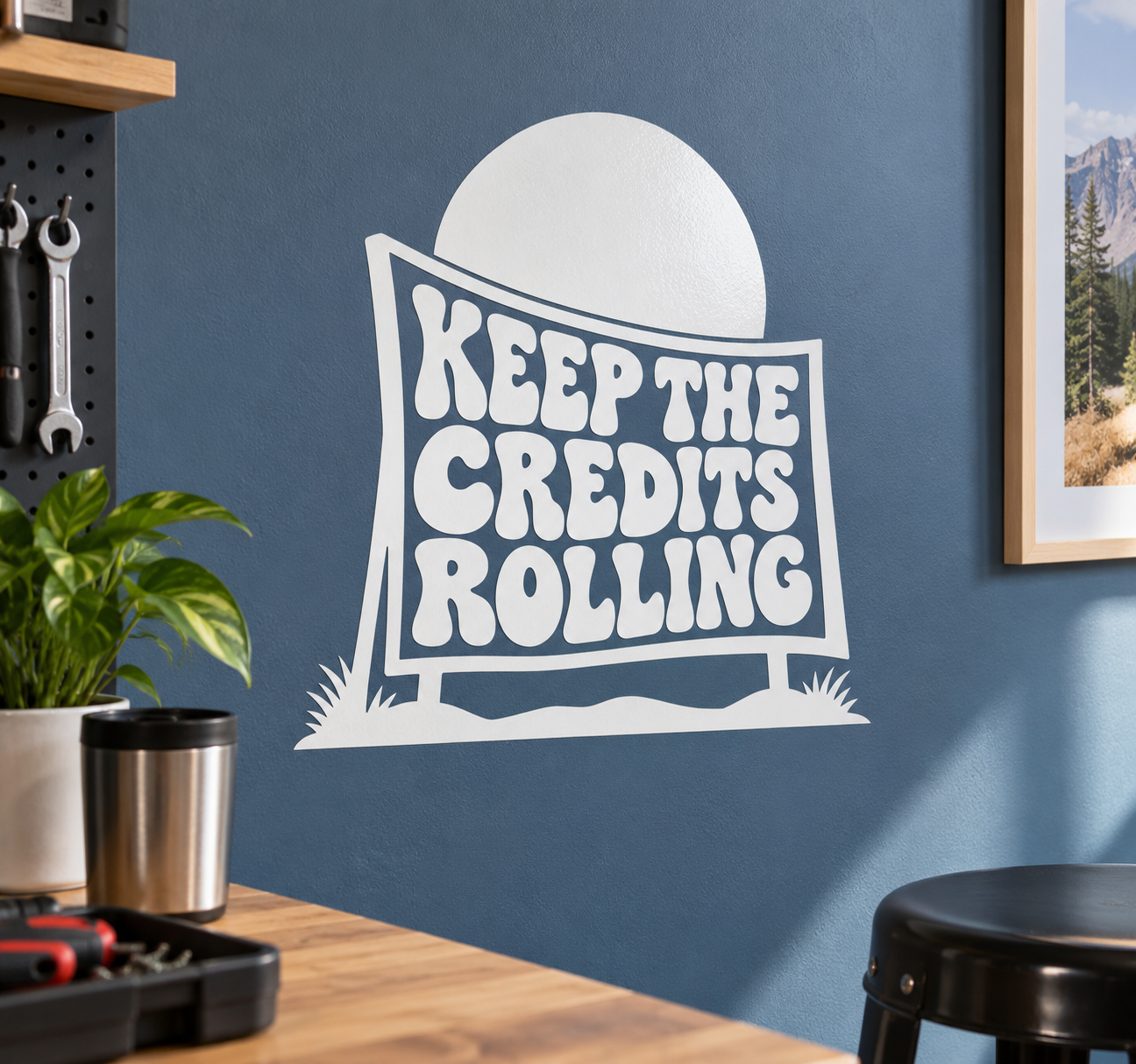 Vinyl decal with white moon and outlined sign reading “KEEP THE CREDITS ROLLING”