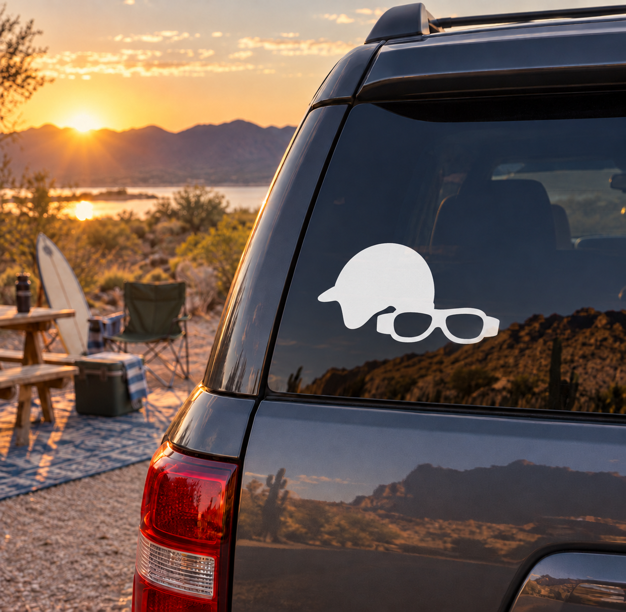 White helmet and goggles vinyl decal on dark car window