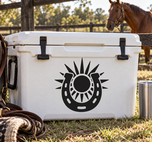 Black horseshoe with sunburst vinyl decal on white surface