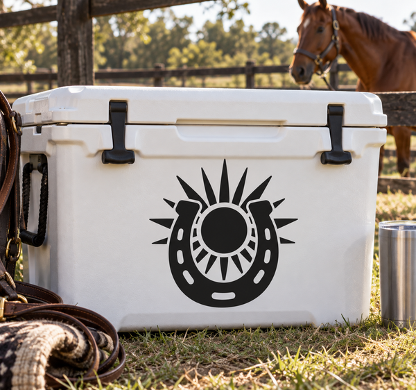 Black horseshoe with sunburst vinyl decal on white surface