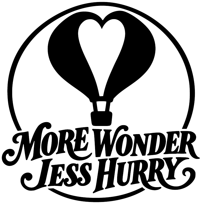 Black-and-white vinyl decal featuring hot air balloon heart and 'More Wonder Less Hurry'