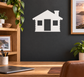 White house silhouette vinyl decal with three window openings on a dark wall