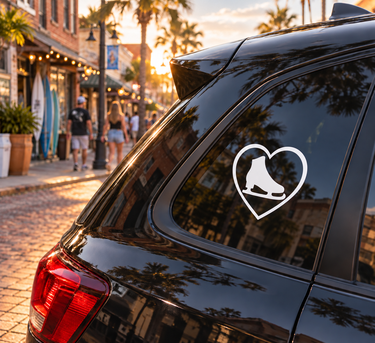 Ice skating heart vinyl decal with black skate silhouette on car window