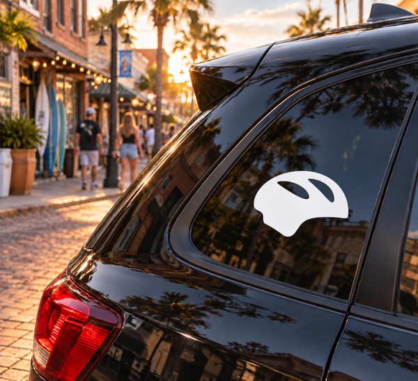 Helmet-shaped vinyl decal, white silhouette on dark window
