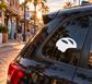 Helmet-shaped vinyl decal, white silhouette on dark window