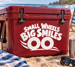 Red vinyl decal: “SMALL WHEELS BIG SMILES” with two wheel icons on a red case