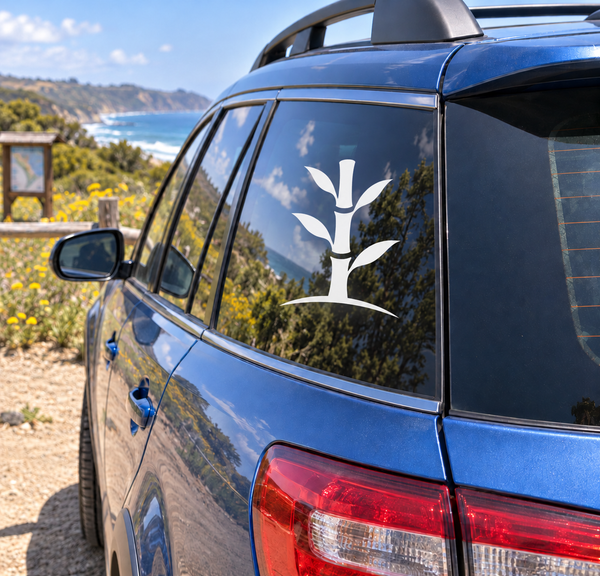 White bamboo-style karate decal on car window, with leaf-like branches and trunk