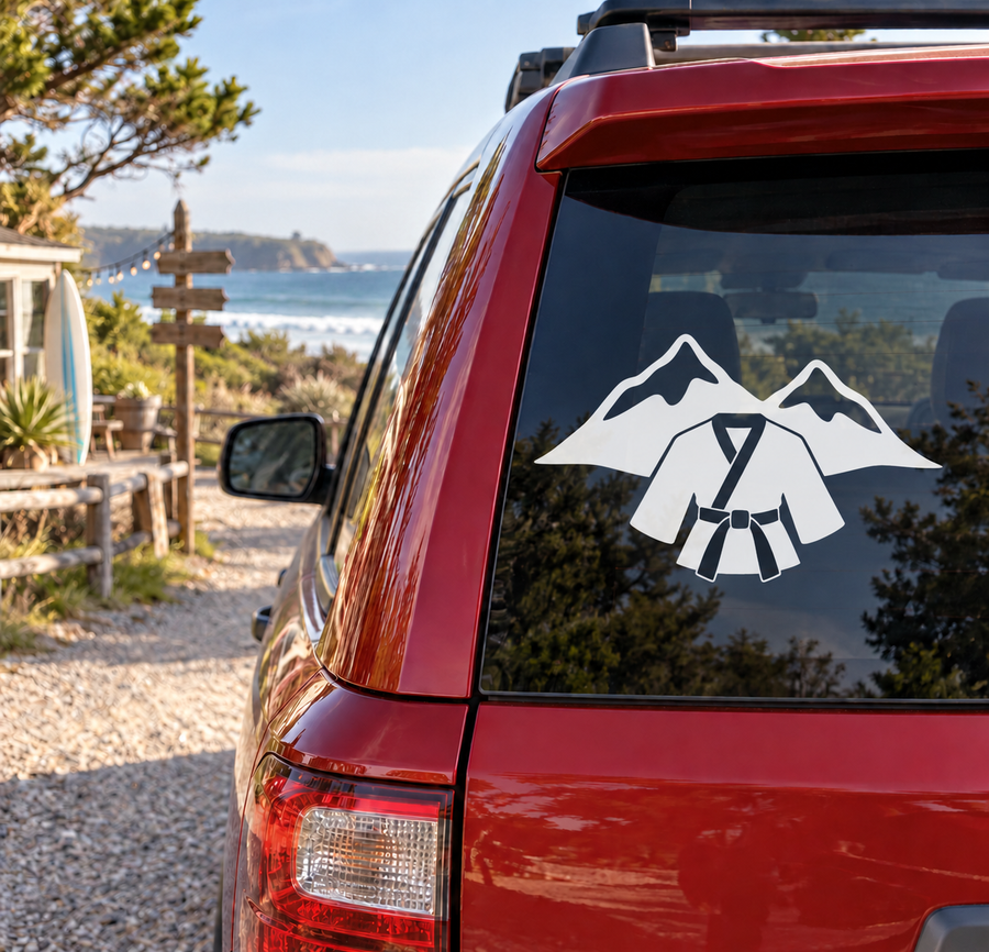Vinyl decal of white mountains and karate gi on a vehicle window