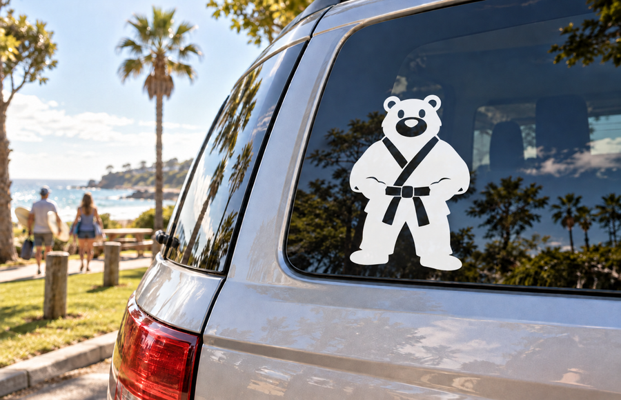 Karate bear vinyl decal: black bear in white karate gi with belt on window