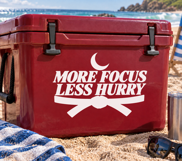 More Focus Less Hurry vinyl decal on red surface with crescent and crossed ribbon