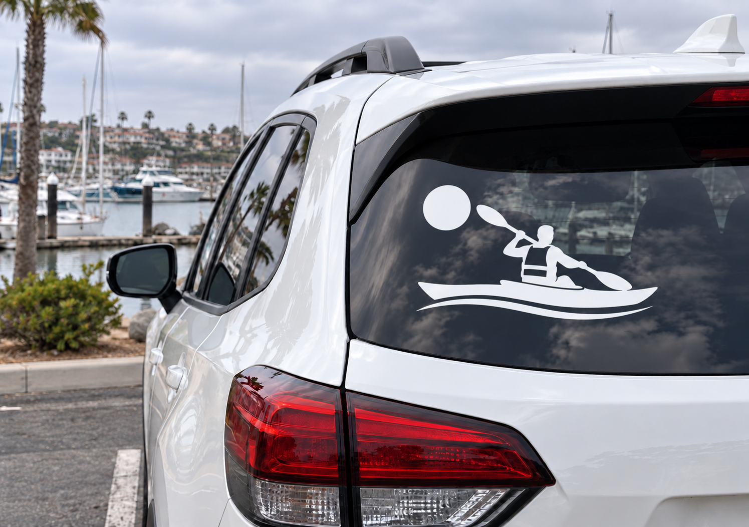 Kayak vinyl decal with rower silhouette and white circle on car rear window