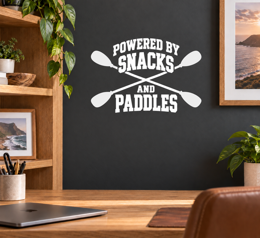 Vinyl decal with white text “Powered by Snacks and Paddles” and crossed paddle icons