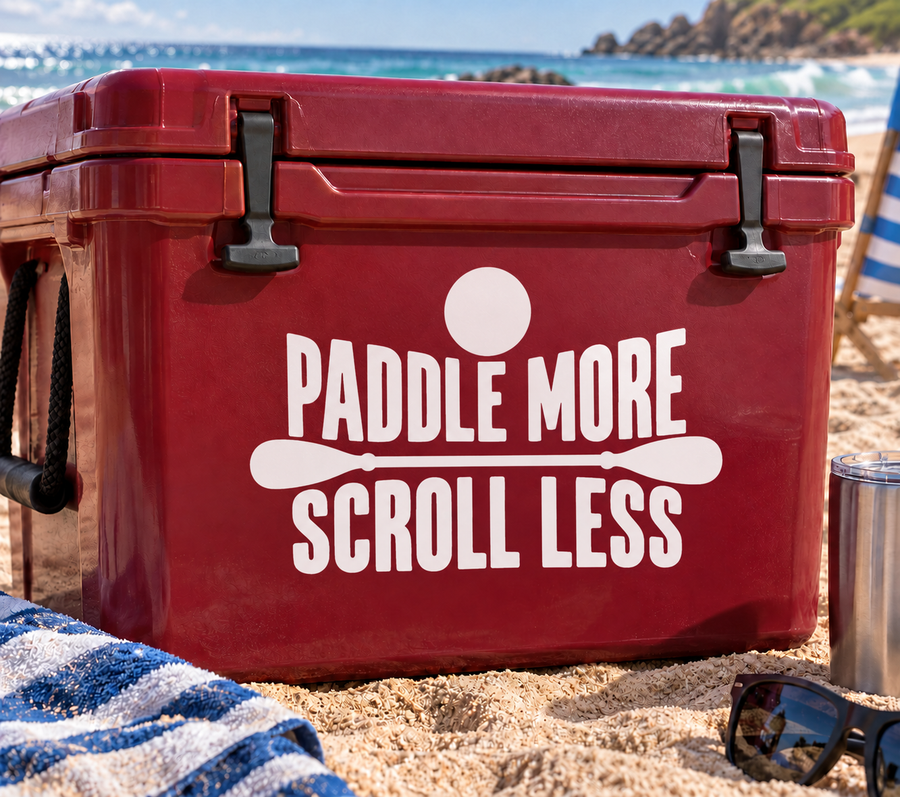 Red cooler vinyl decal: “PADDLE MORE SCROLL LESS” with paddle icon