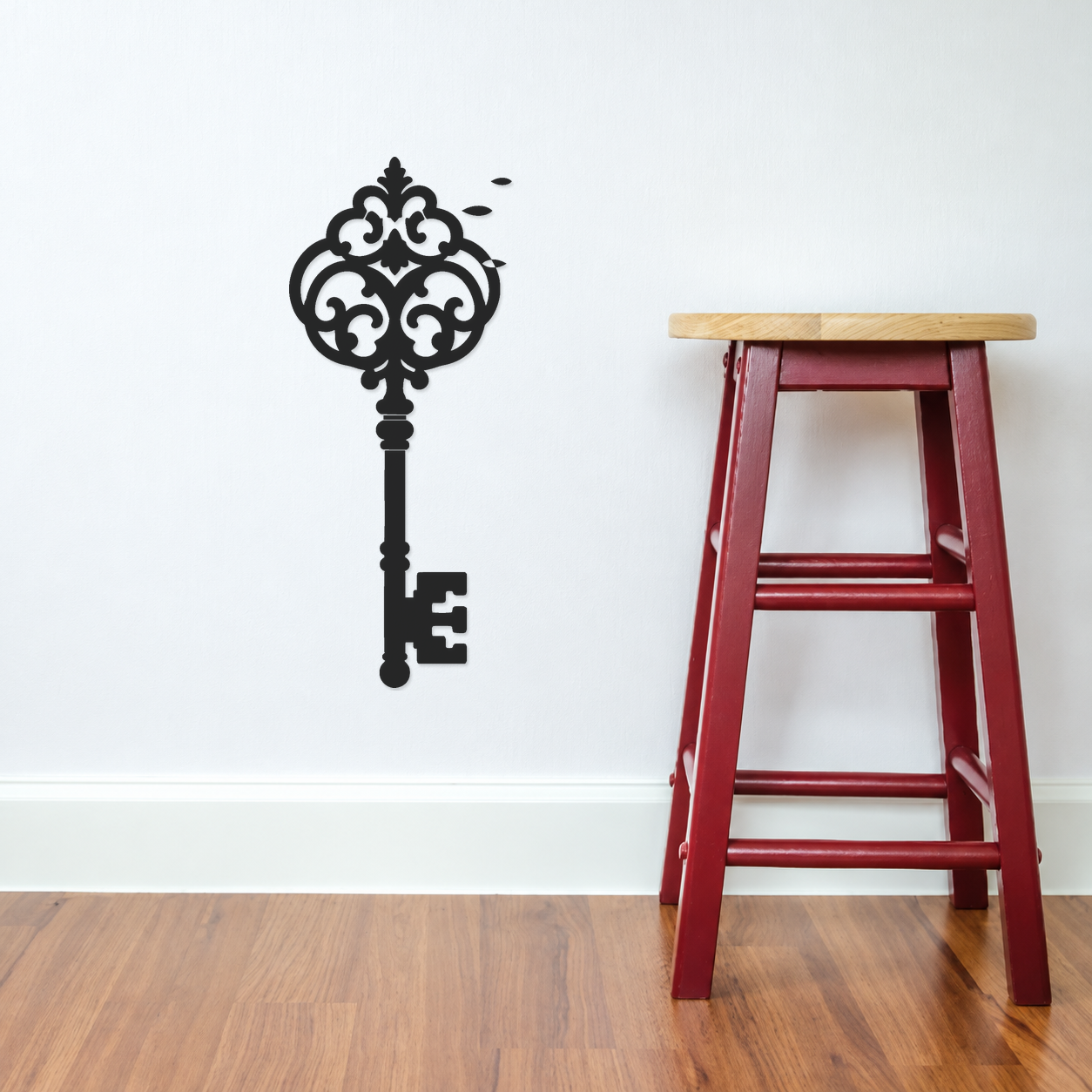 Ornate black scroll skeleton key wall decor with laurel-style leaf cluster at top