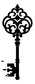 Close-up ornate skeleton key wall decor with filigree scrolls and leaf-like crest
