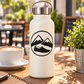 Vinyl decal badge with black mountain and wave logo on white surface