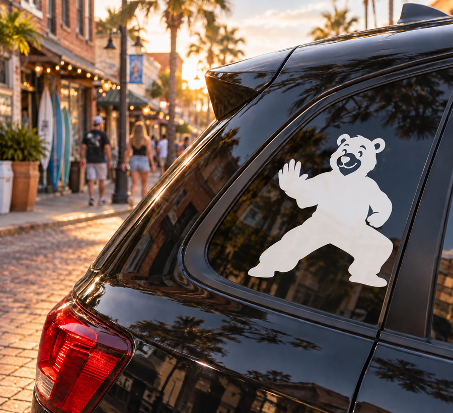 Car window vinyl decal of a white kung fu bear waving on a dark background