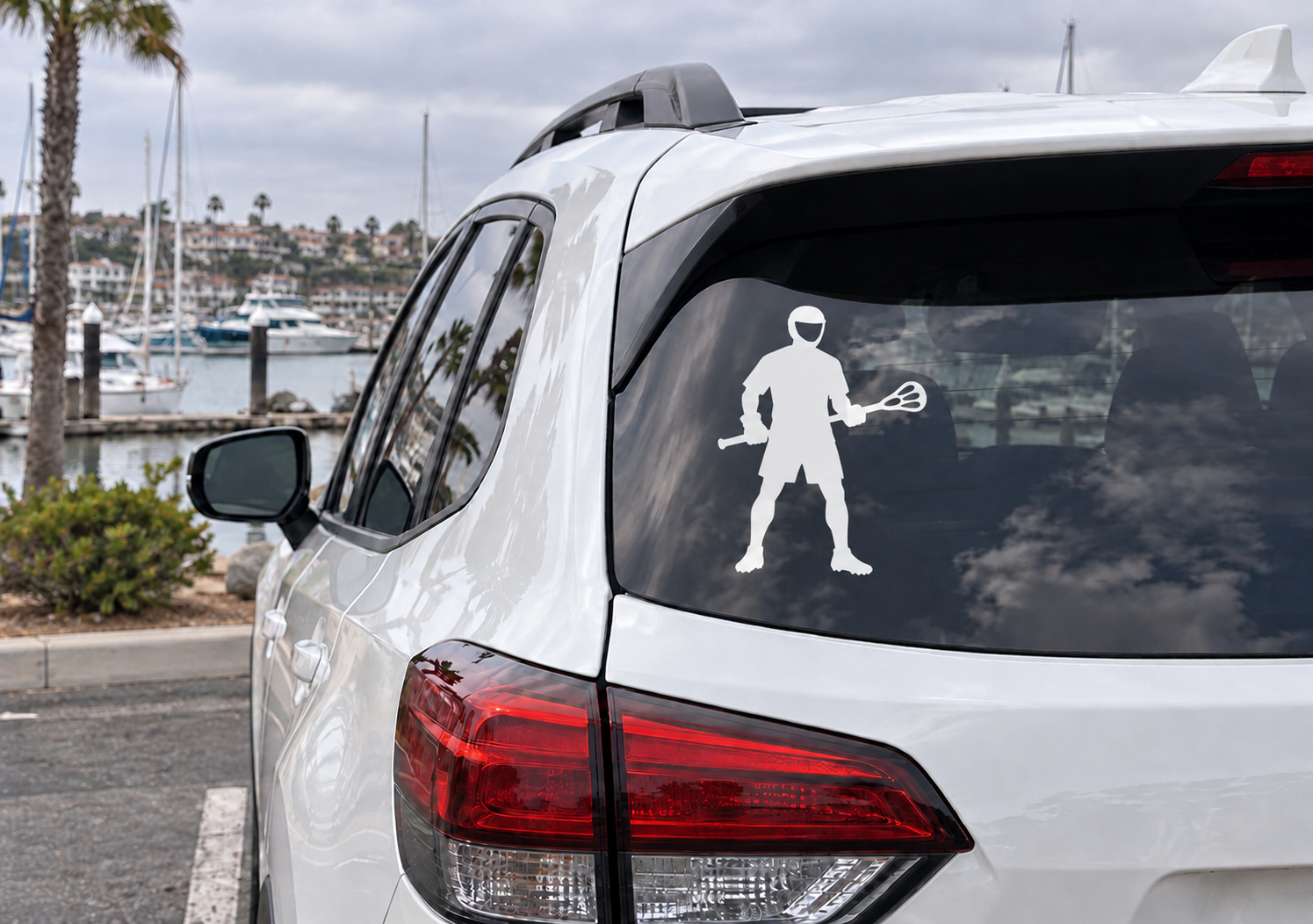 Vinyl lacrosse player decal, white silhouette with stick on car rear window