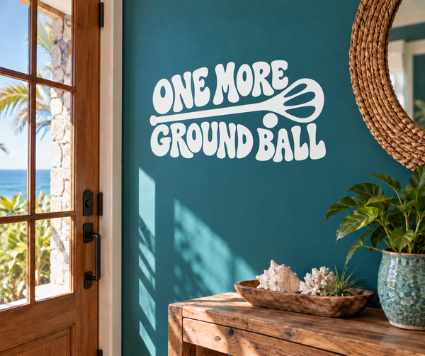 Lacrosse vinyl decal: white 'ONE MORE GROUND BALL' lettering with winged ball icon