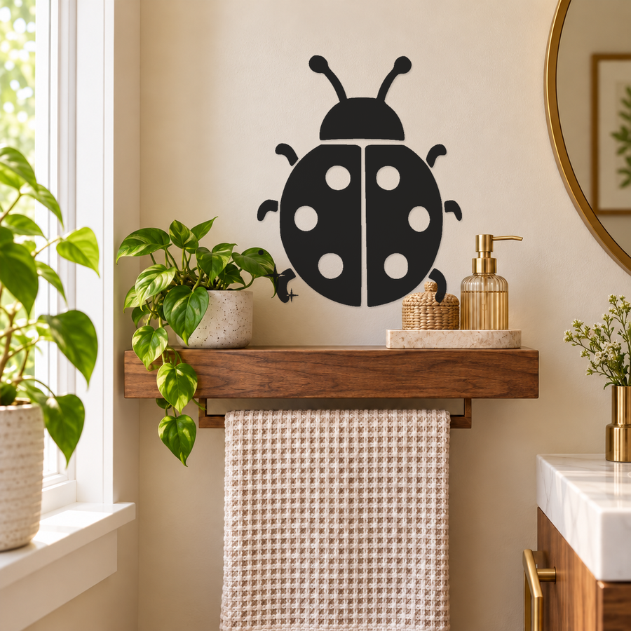 Black ladybug wall decal with white spots and mirrored vertical stripe on wall