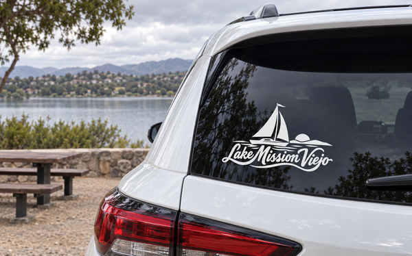 White vinyl decal of Lake Mission Viejo sailboat wordmark on car window