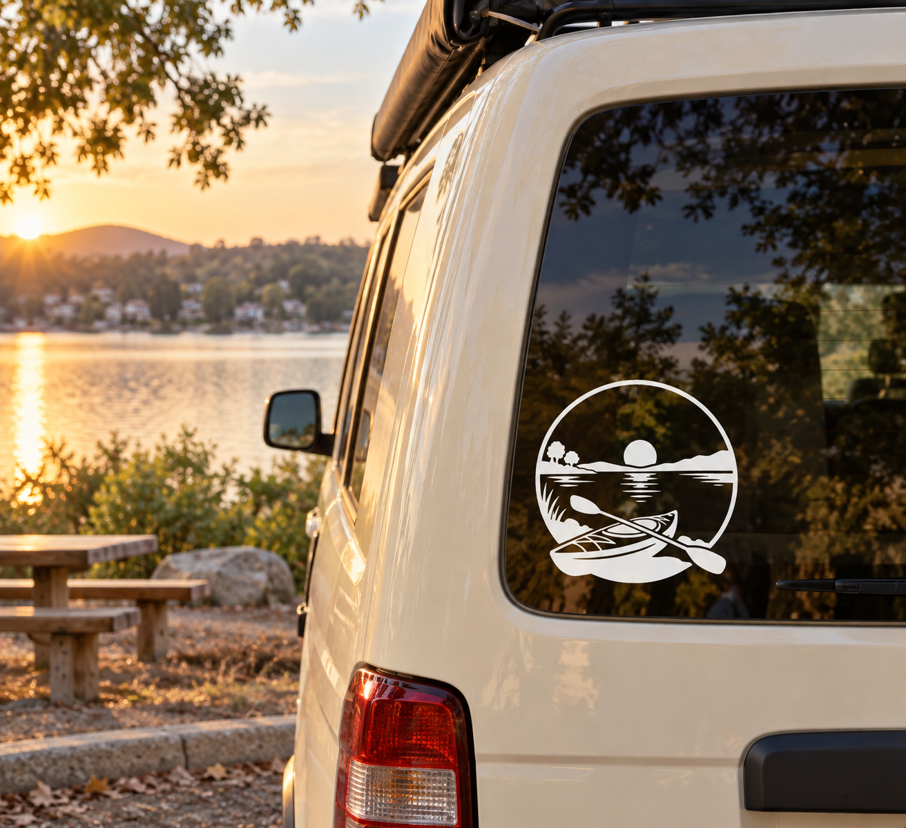 Round vinyl kayak and fish decal in black and white on a car window