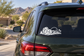 Lucky dice icon vinyl decal on car rear window, black skyline silhouette with palm trees