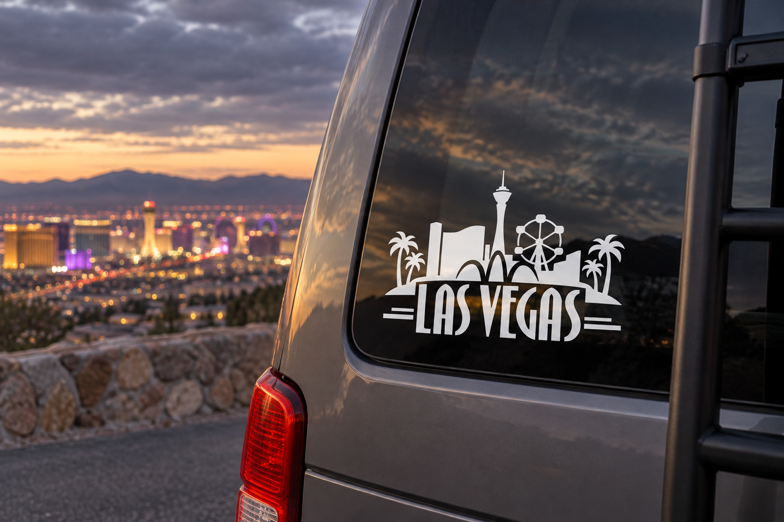 White Las Vegas skyline wordmark vinyl decal on dark window with palm trees and tower icons