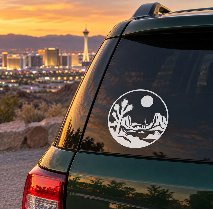 Round white vinyl decal with desert skyline, cactus, and moon on car window