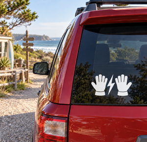 Vinyl decal of two black glove icons with white lightning bolt on car window