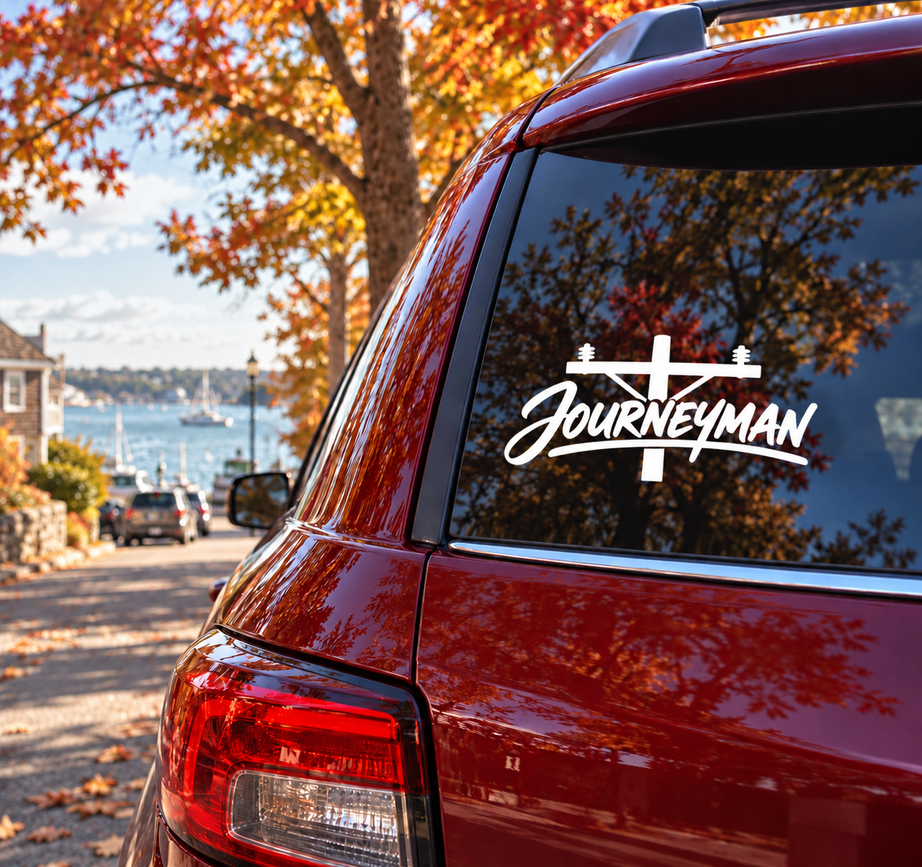 Vinyl decal with black cross and “Journeyman” lettering for car rear window