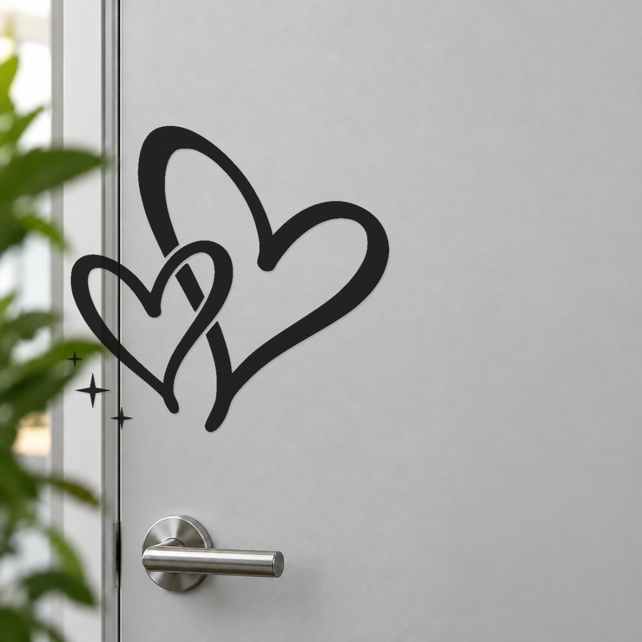 Black interwoven hearts door decal with flowing tails and three star spark marks