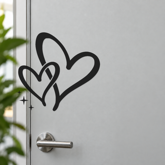 Black interwoven hearts door decal with flowing tails and three star spark marks