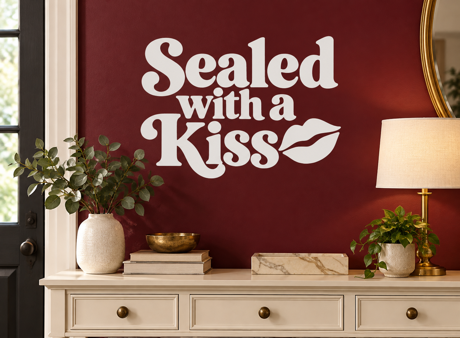 Sealed with a Kiss vinyl decal with white lettering and kiss lip graphic on dark red wall