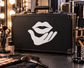 Vinyl lips-and-hand gesture decal in white on a dark surface, applied to a case