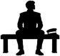 Black vinyl decal silhouette of seated marching band musician at a drum