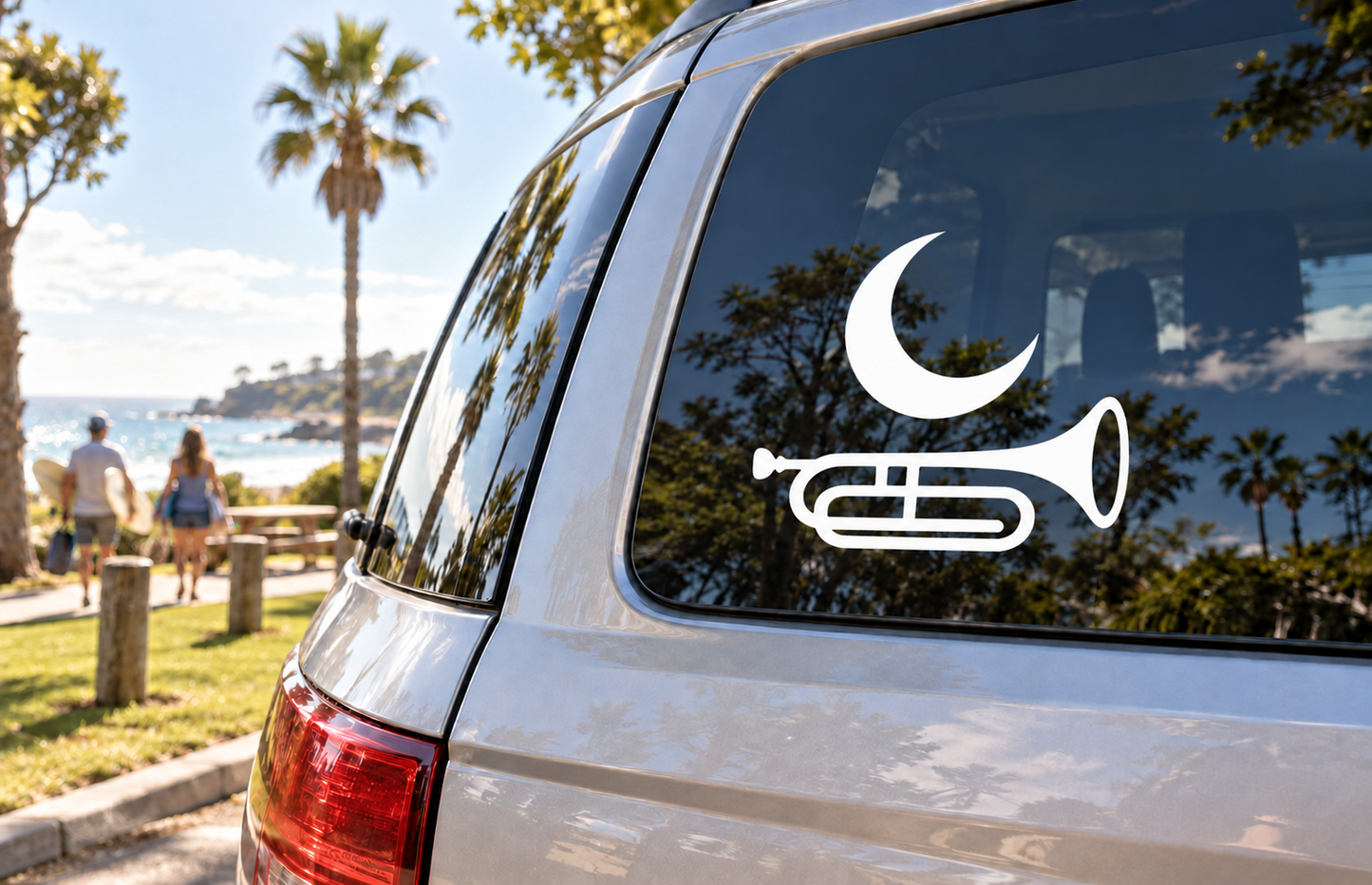 Black vinyl decal of crescent moon and trumpet on car window