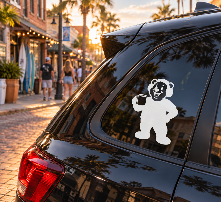 Coffee vinyl decal featuring a smiling bear holding a mug on a car window