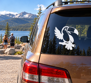 Toucan vinyl decal on car window, black-and-white bird mascot with beak open