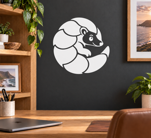 Pangolin mascot vinyl decal in a white circle on dark surface