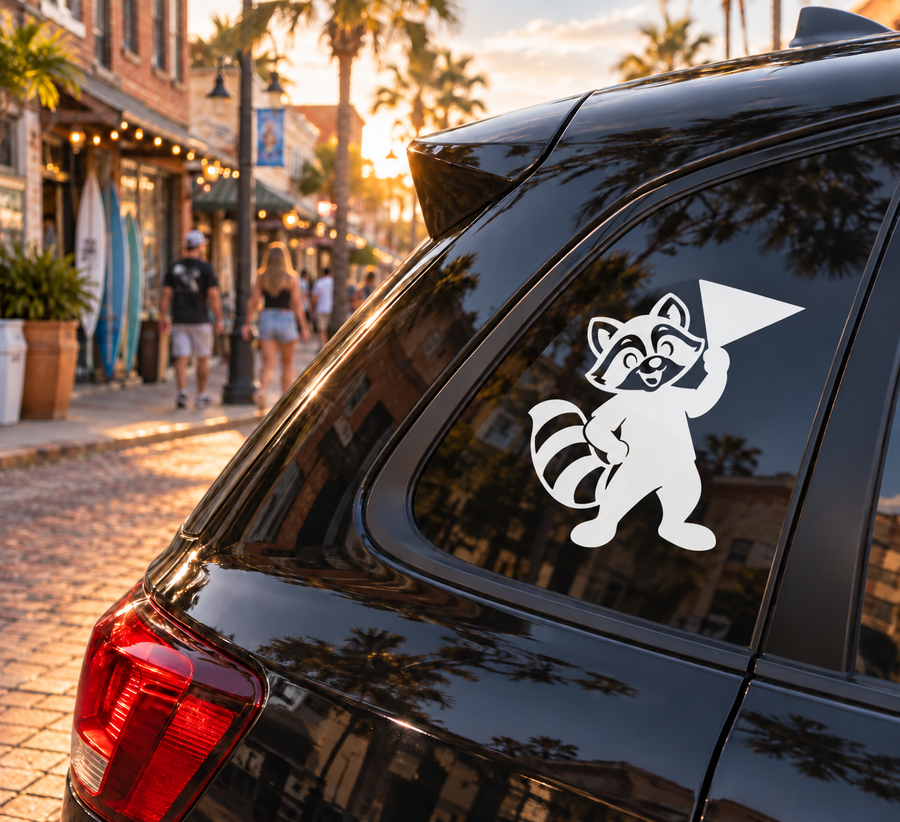 Black and white raccoon mascot vinyl decal on car window, rally-ready design