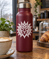 Lion sunburst face vinyl decal on maroon bottle, white outlined sun-mask design