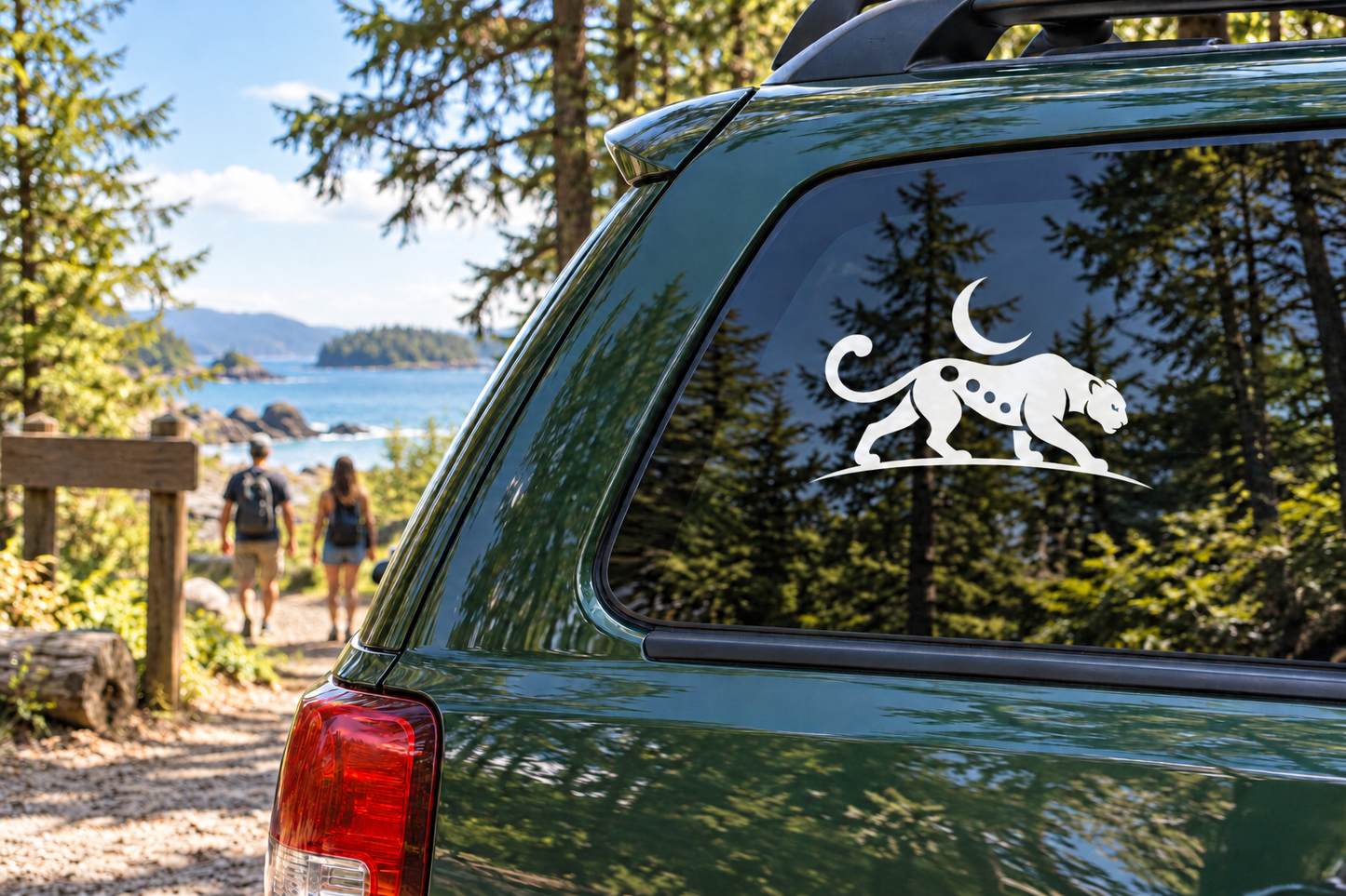 Vinyl decal of black jaguar prowling under a moon on a car window